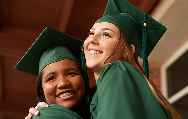 Two girls in graduation caps and gowns